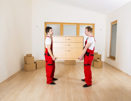 Worker handling a boxed item carefully during a removal job